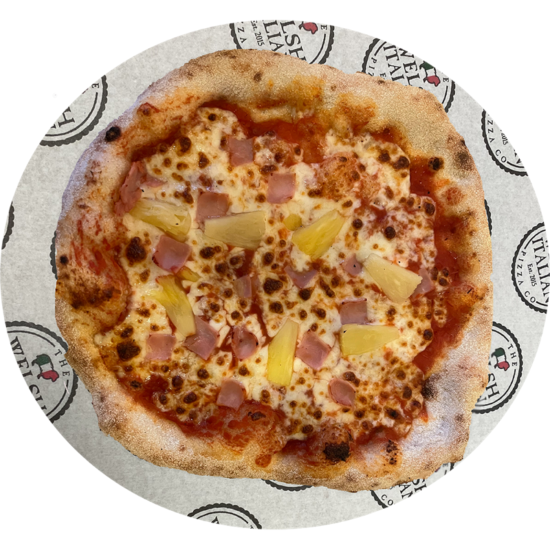 A Hawaiian pizza with ham and pineapple chunks