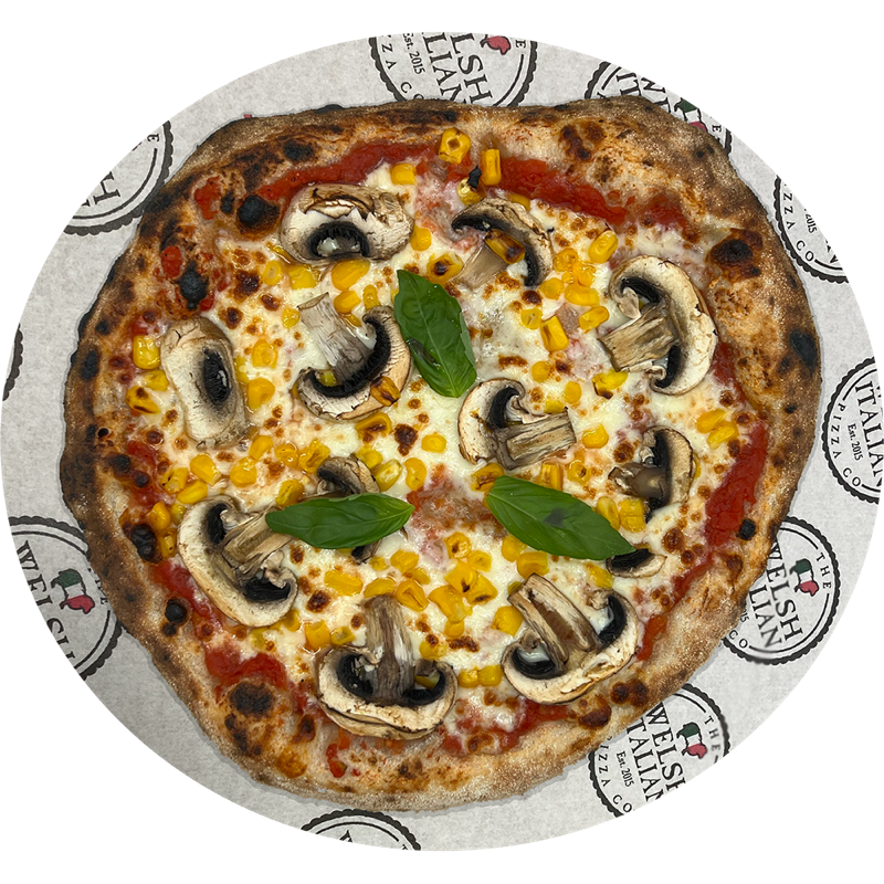 A mushroom and sweetcorn pizza finished with fresh basil