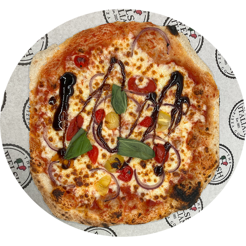 A veg supreme pizza with pearl peppers, red onion and balsamic drizzle